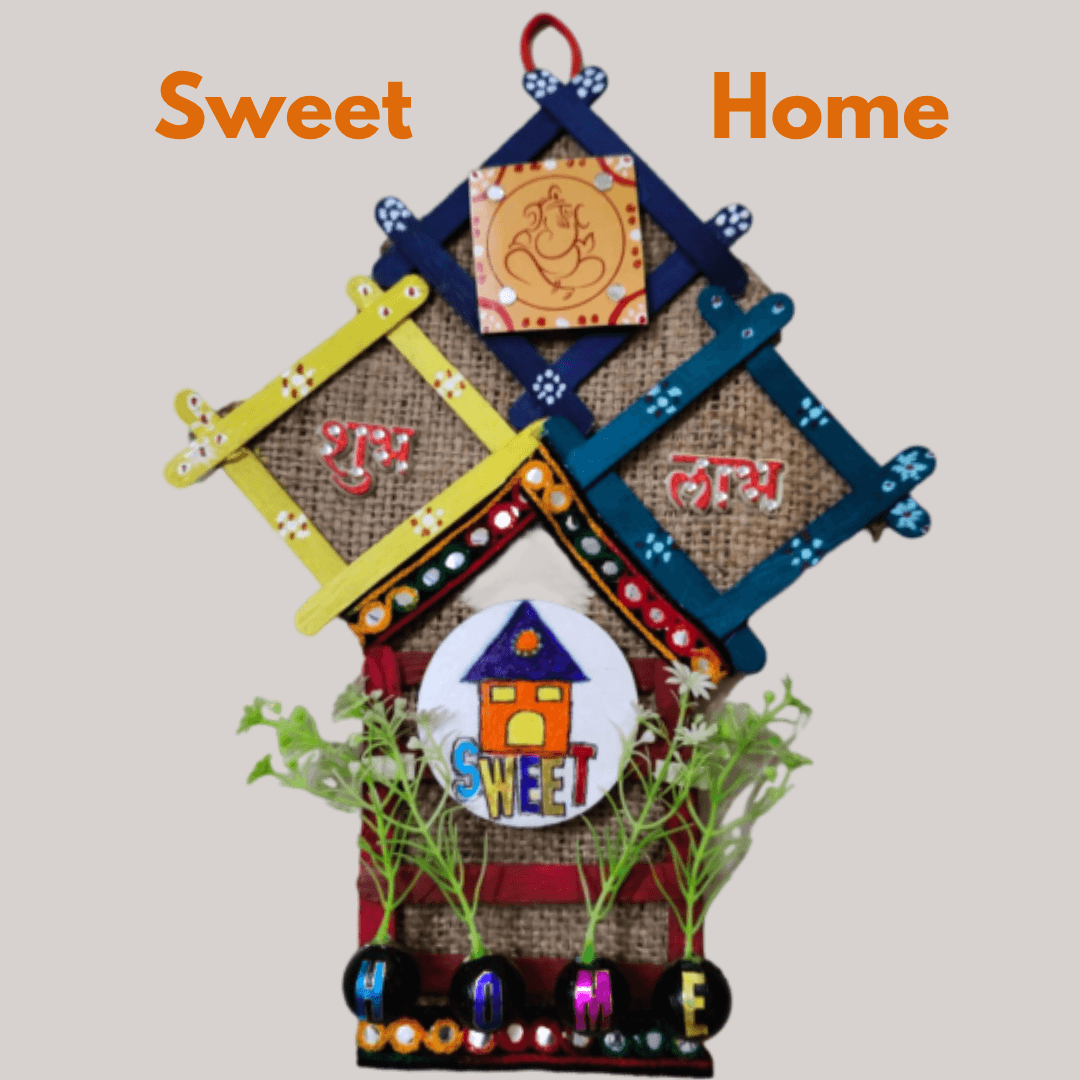 Handmade Sweet Home wall hanging craft created using popsicle sticks, burlap, and upcycled waste material