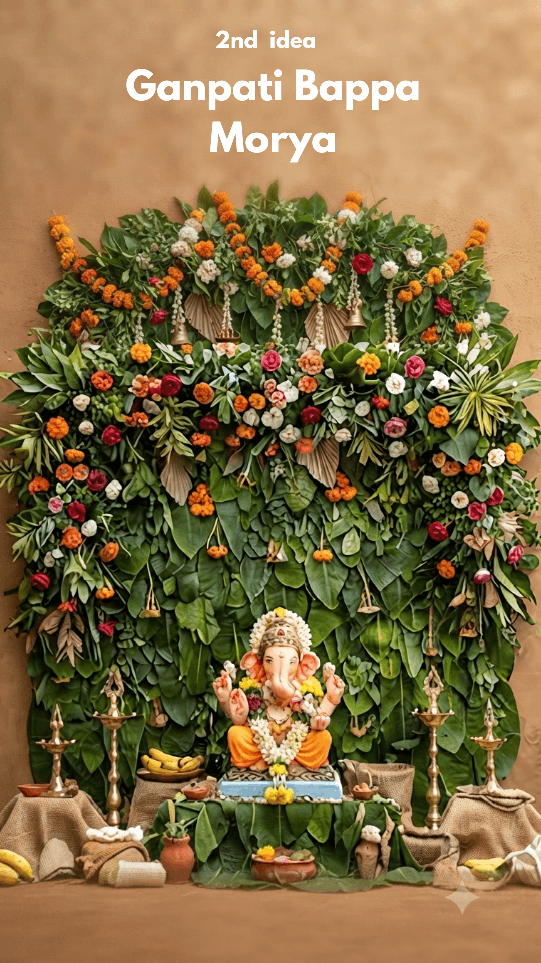 Lord Ganesha idol seated in front of a dense wall decoration made of green leaves, colorful flowers, and brass lamps.
